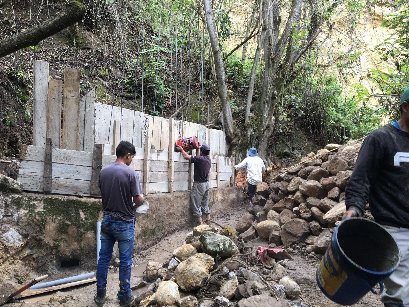 Team members work on the spring box water collection system.